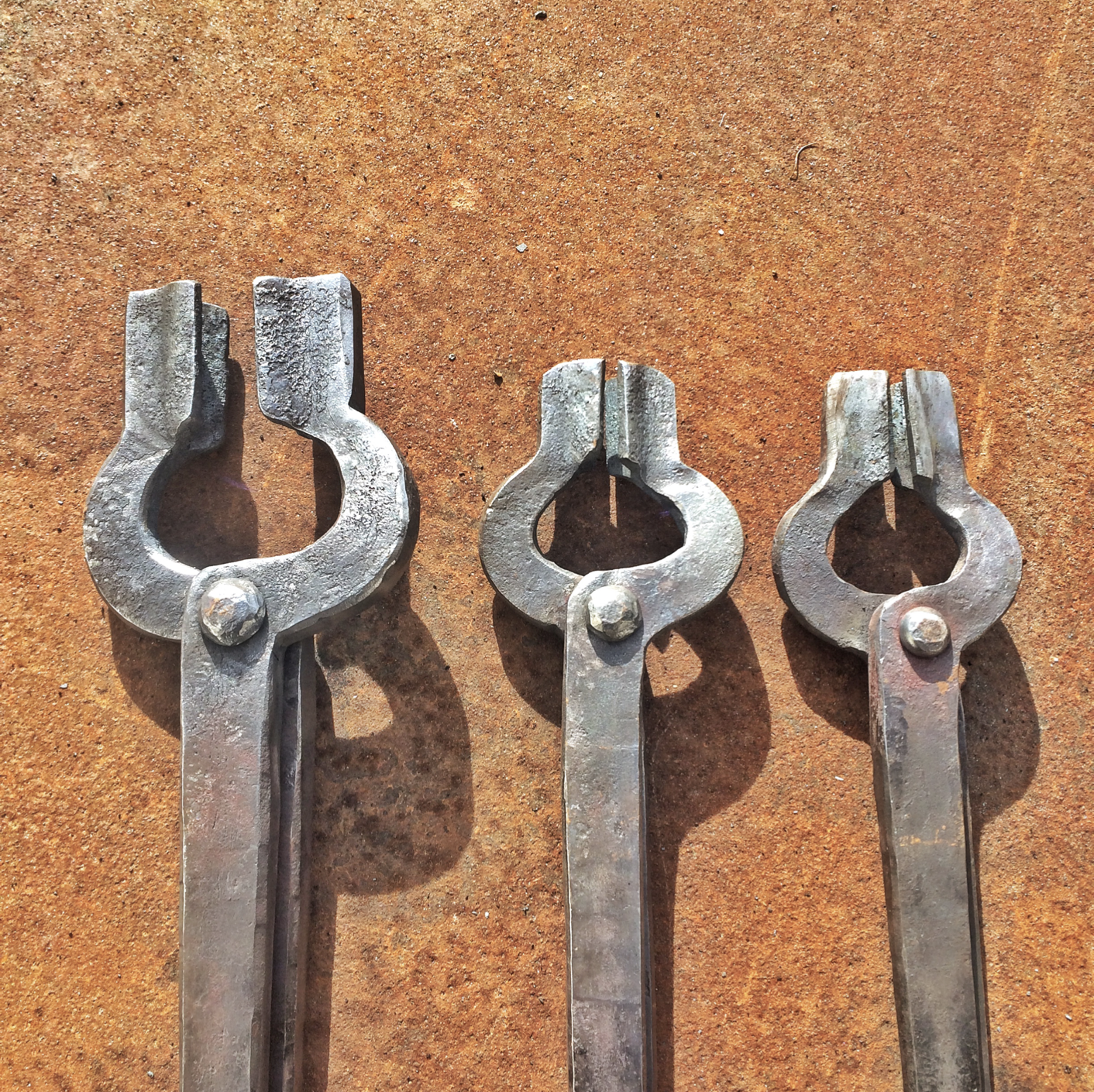 Three pairs of tongs. Variety of sizes